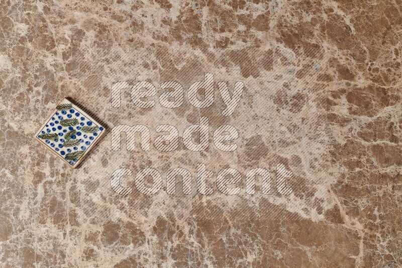 A decorative coaster on beige marble background