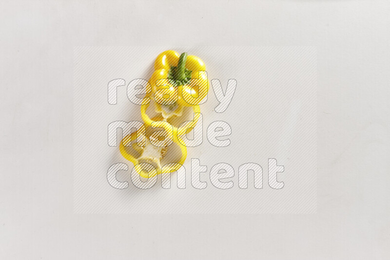 Yellow bell pepper slices on white background