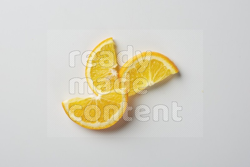 Three halves of an orange slices on white background