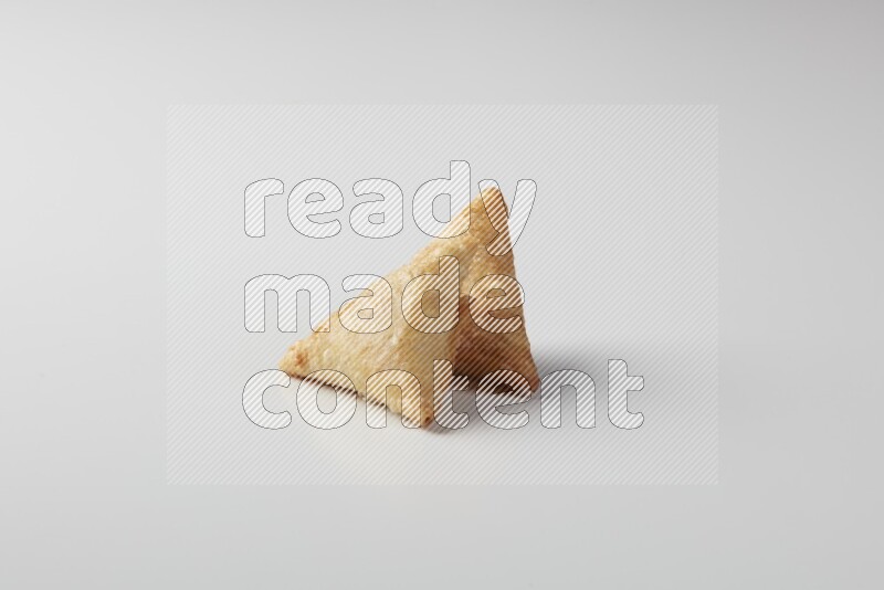 Two fried sambosas on a white background