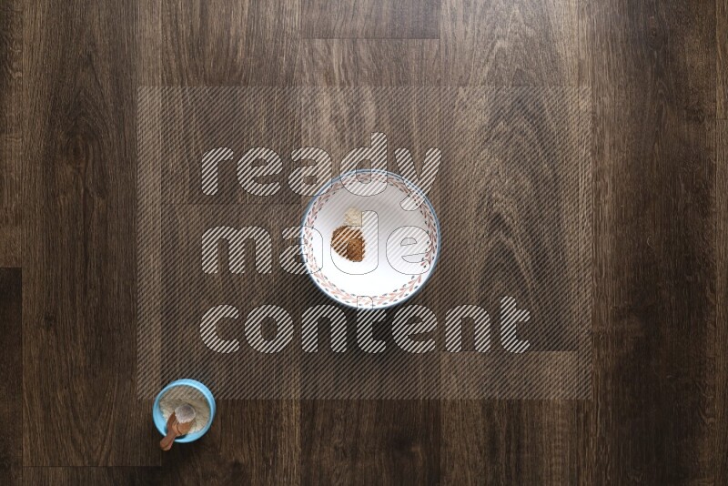 A bowl full of spices and salad dressing ingredients on wooden background