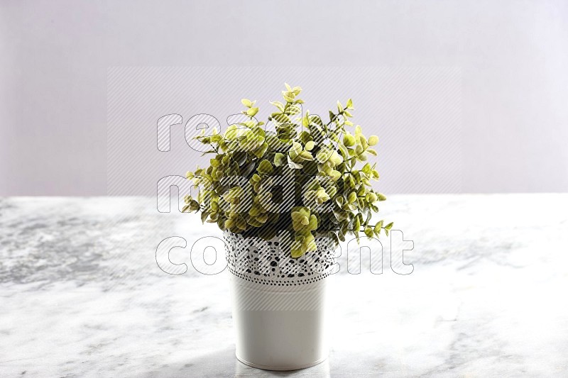 Artificial Plant in White Decorative Pot on Light Grey Marble Background 45 degree angle