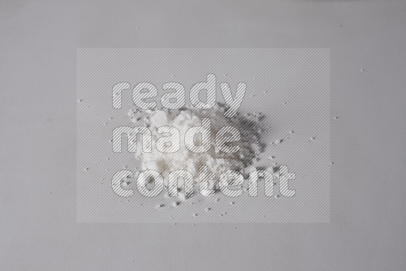 A bunch of coarse sea salt crystals on white background