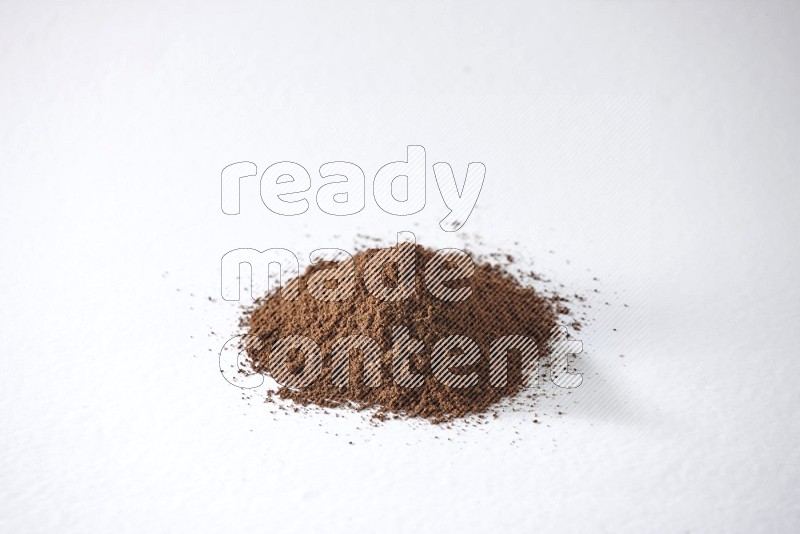 A pile of cloves powder on a white flooring
