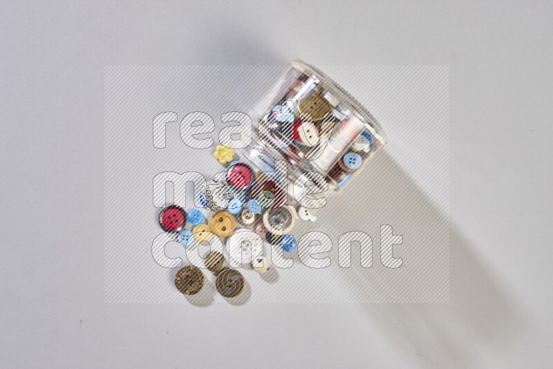 Mixed assorted buttons on grey background