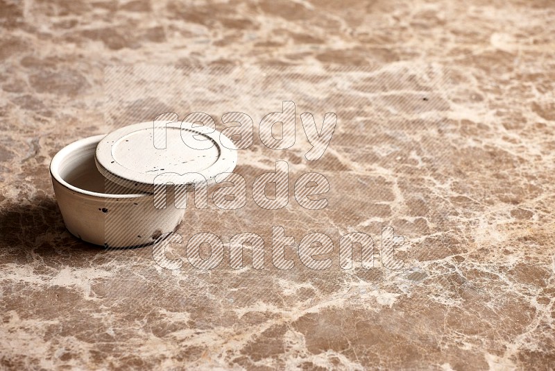 White Pottery Bowl on Beige Marble Flooring, 45 degrees