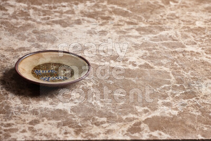 Decorative Pottery Plate on Beige Marble Flooring