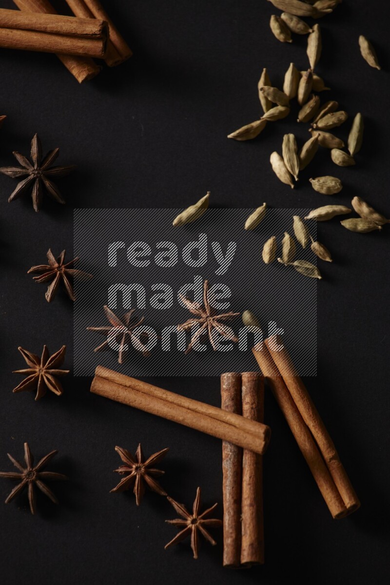 Cinnamon Sticks, Cardamom and star anise on a black background