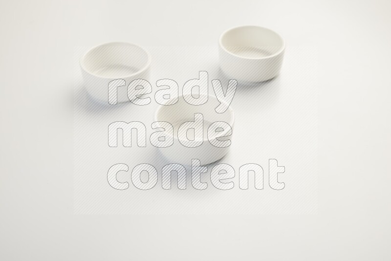 white ceramic round sauce dish on white countertop