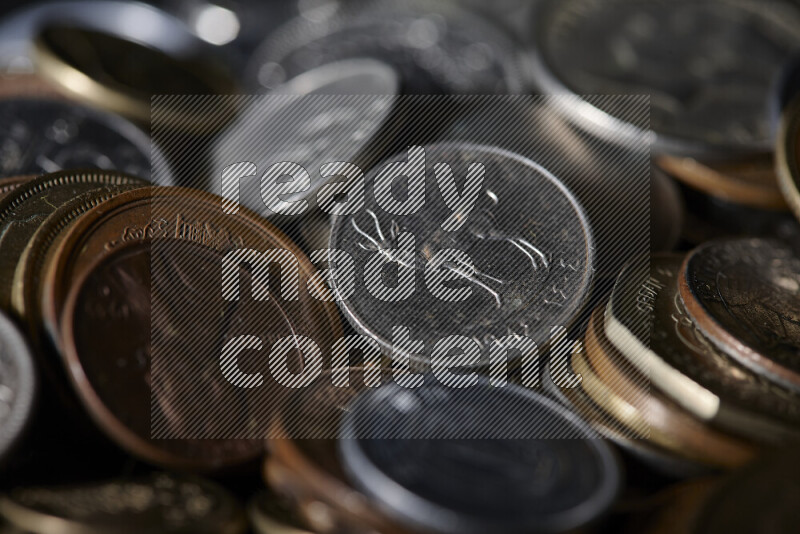 A close-ups of random old coins on black background