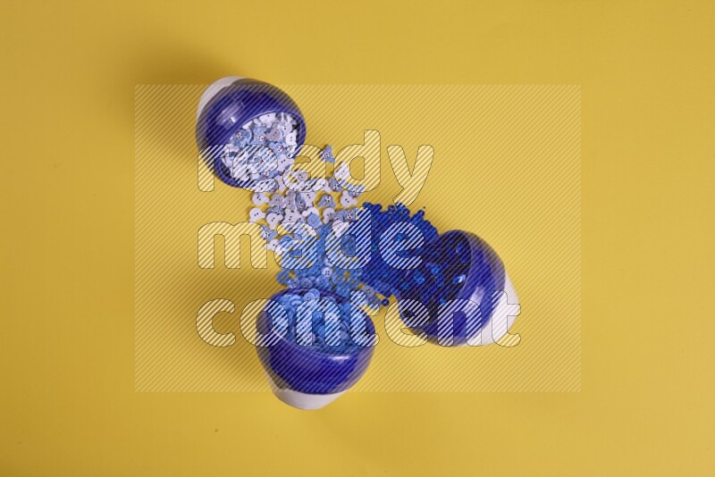 A blue collection of sewing and tailoring tools arranged on a yellow background