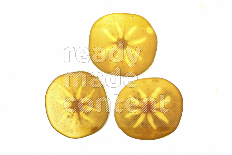 Persimmon slices on illuminated white background