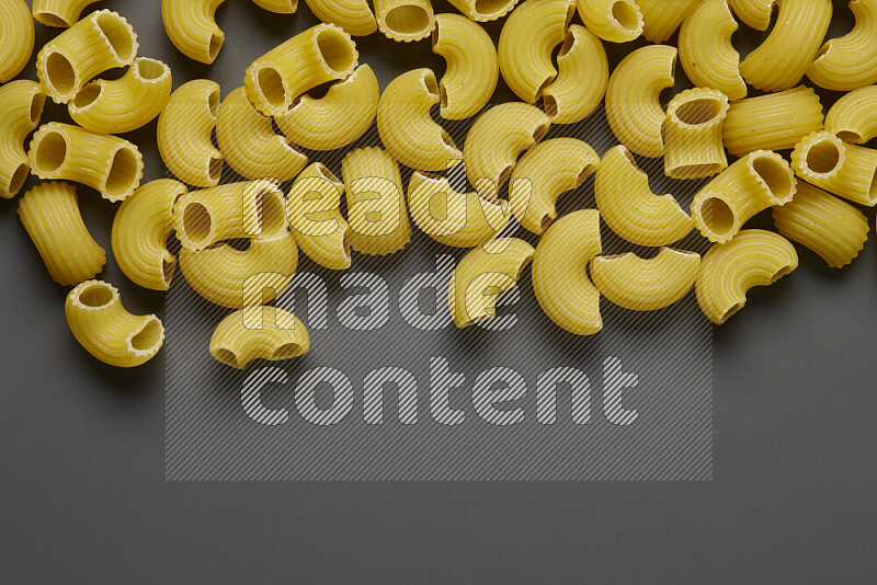 Elbow pasta on grey background