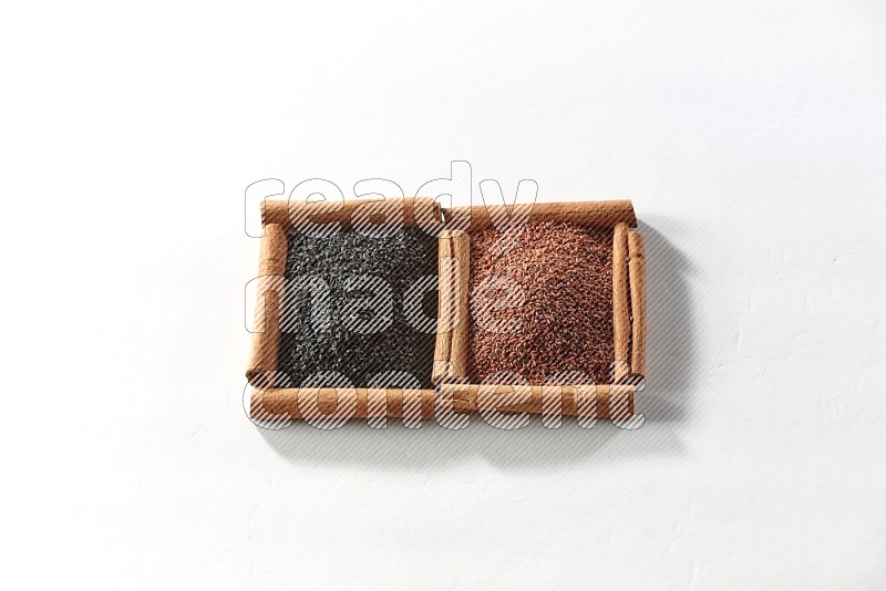 2 squares of cinnamon sticks full of black seeds and garden cress on white flooring