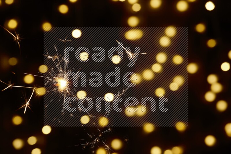 Sparkler candle with yellow light bokeh background