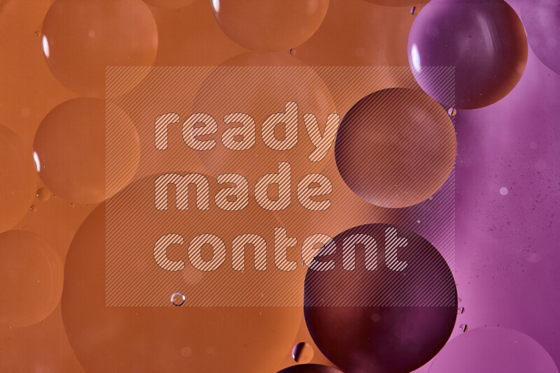 Close-ups of abstract oil bubbles on water surface in shades of orange and pink