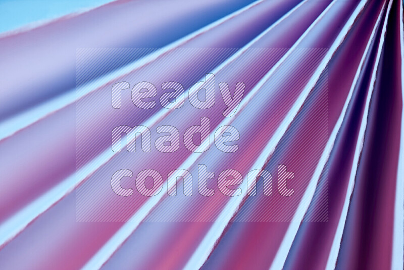 An image presenting an abstract paper pattern of lines in blue and pink tones