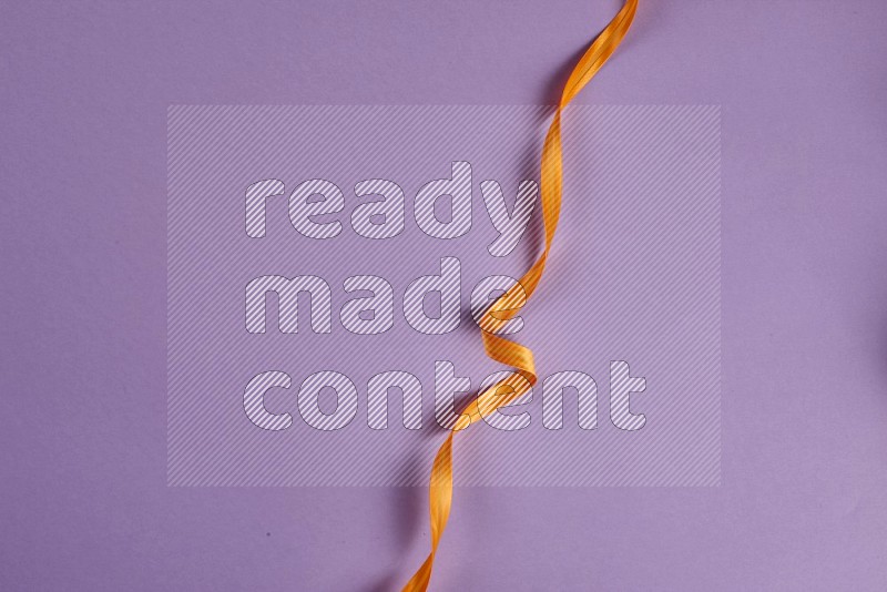 Orange sewing supplies on purple background