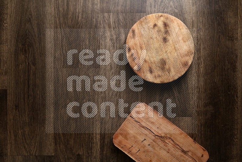 Wooden (chopping boards, spoon, salt and pepper pinch pot), juice jar and a napkin on wooden background