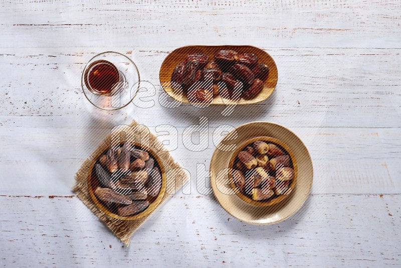 Dates in wooden plates with a drink in a light setups