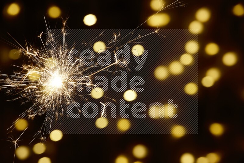Sparkler candle with yellow light bokeh background