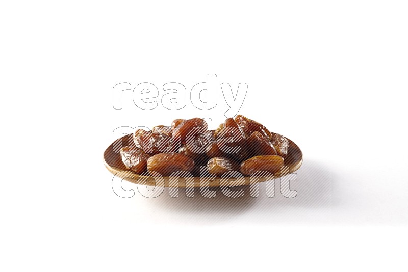 Dates in a wooden plate on white background