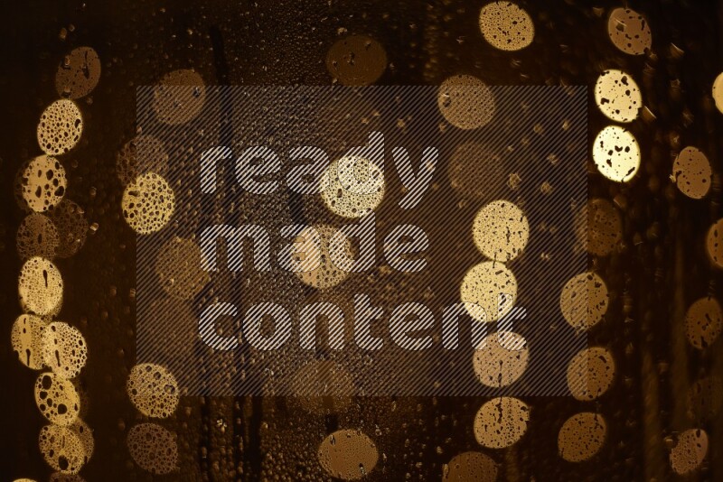 Bokeh light in yellow with water drops