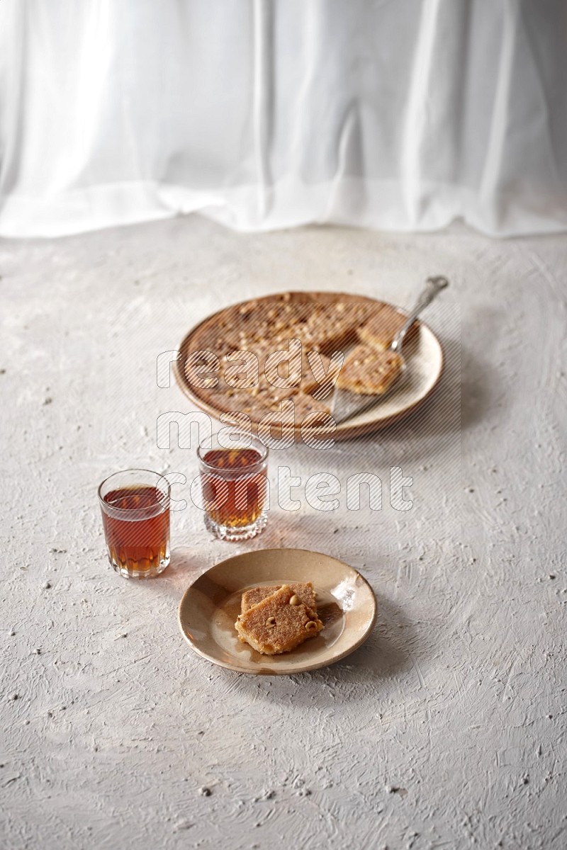 Basbousa with tea in a light setup