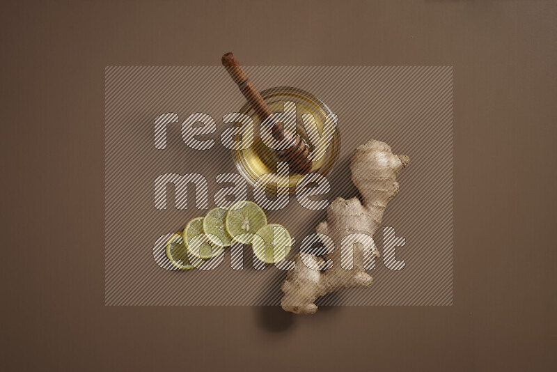 Fresh ginger root with different ingredients such as lemon, orange, honey, ground ginger on beige baackground