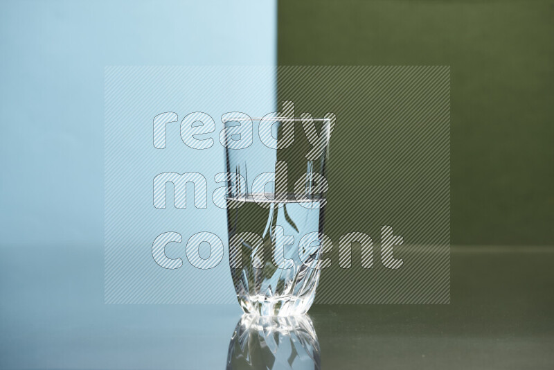 The image features a clear glassware filled with water, set against light blue and dark green background