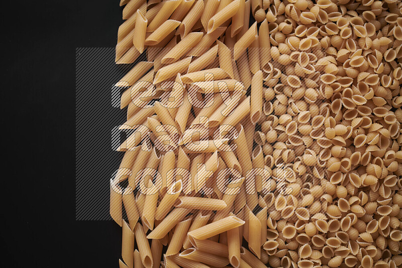 Different pasta types on black background