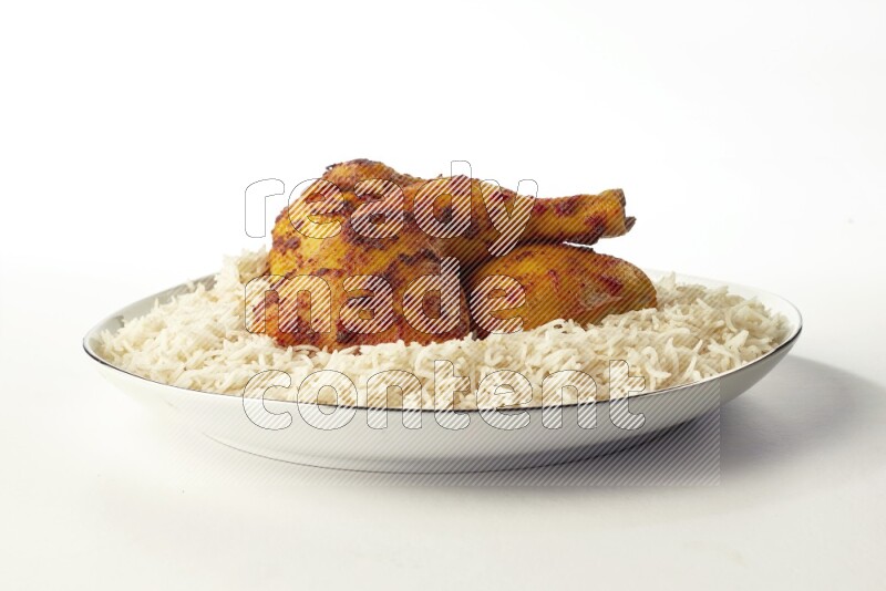 white basmati Rice with kabsa chicken pieces on a white plate with a silver rim direct on white background