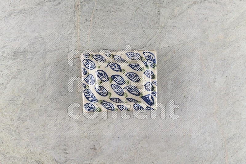 Top View Shot Of A Decorative Pottery Plate On Grey Marble Flooring