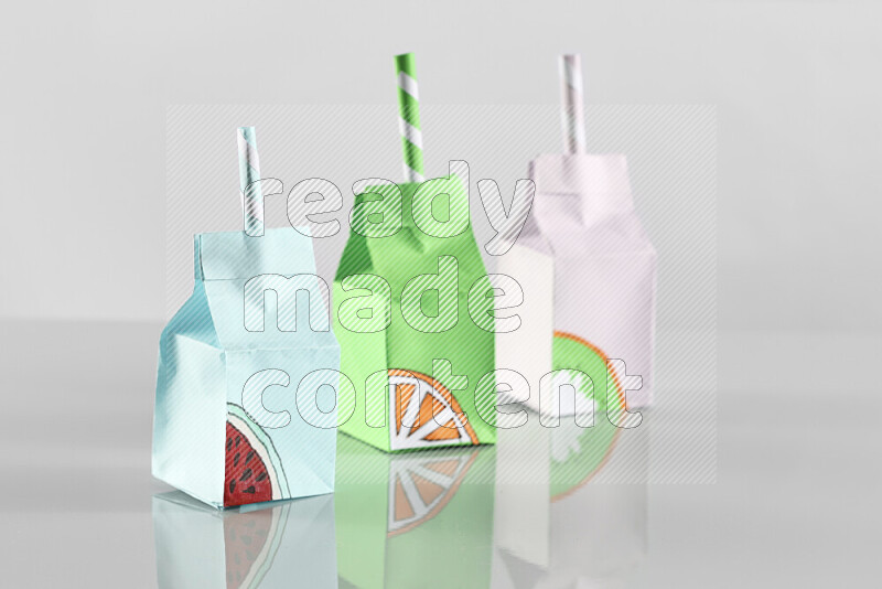 Origami juice box on grey background