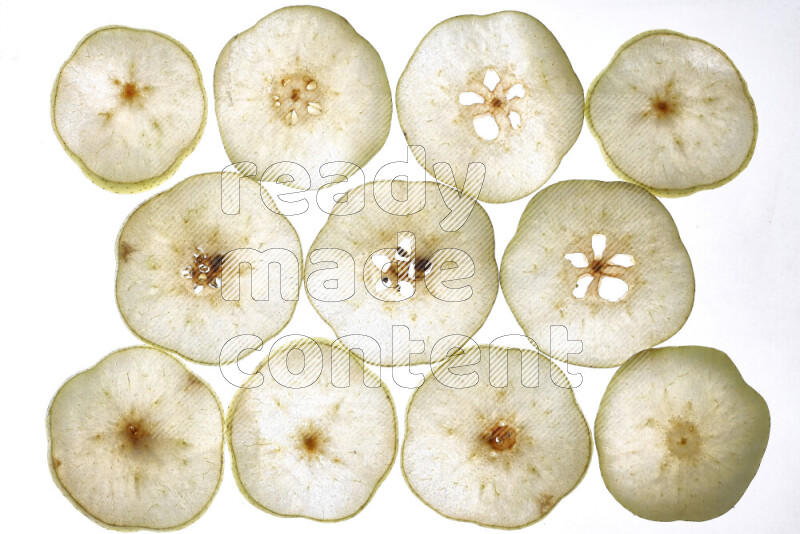 Pear slices on illuminated white background