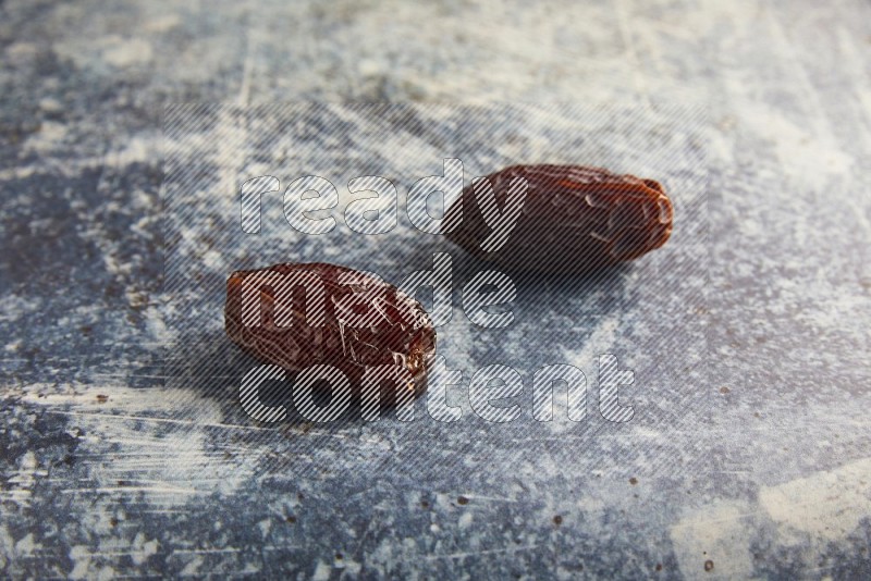 two madjoul dates on a rustic blue backround
