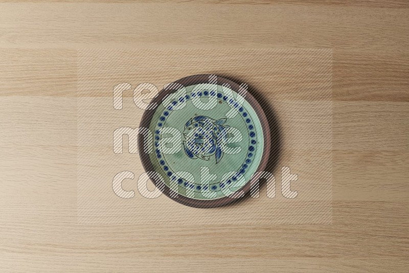 Top View Shot Of A Decorative Pottery Plate on Oak Wooden Flooring