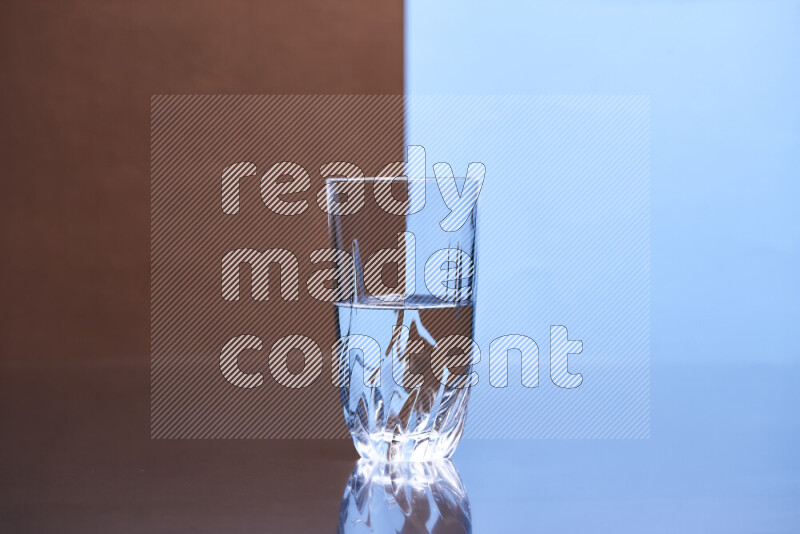 The image features a clear glassware filled with water, set against brown and light blue background