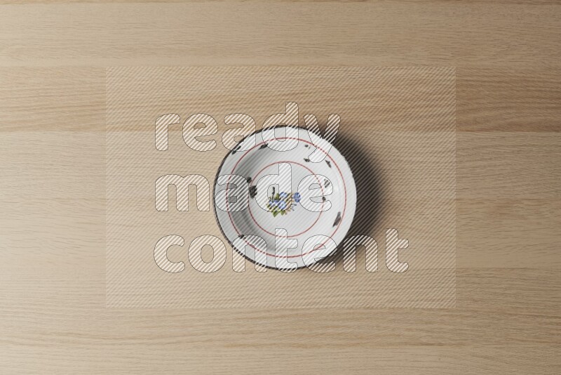 A vintage metal plate on light wooden background