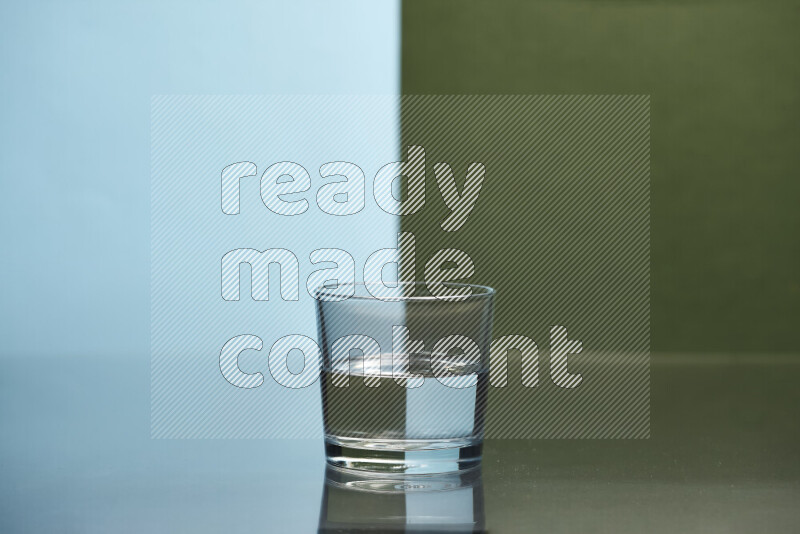 The image features a clear glassware filled with water, set against light blue and dark green background