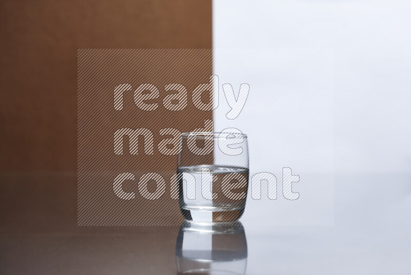 The image features a clear glassware filled with water, set against white and brown background