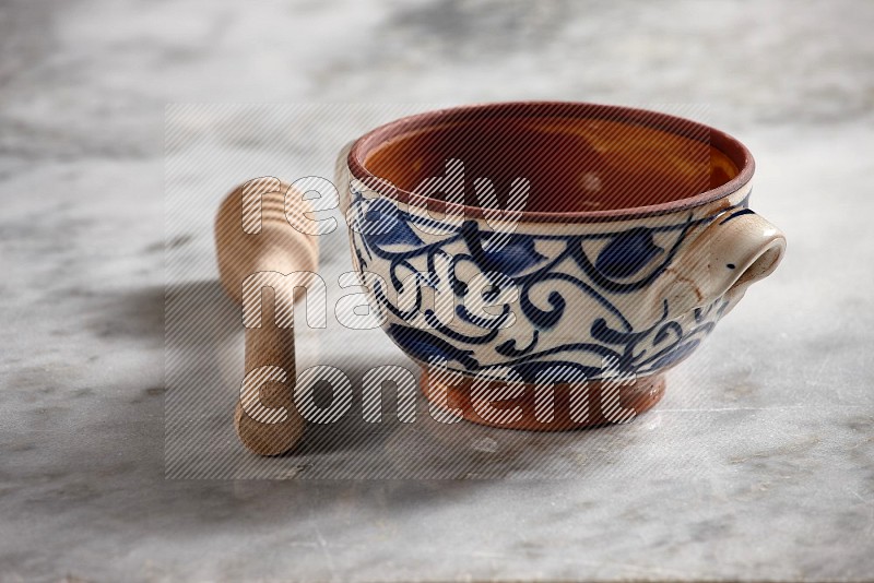 Decorative Pottery pot with wooden honey handle on the side with grey marble flooring, 15 degree angle