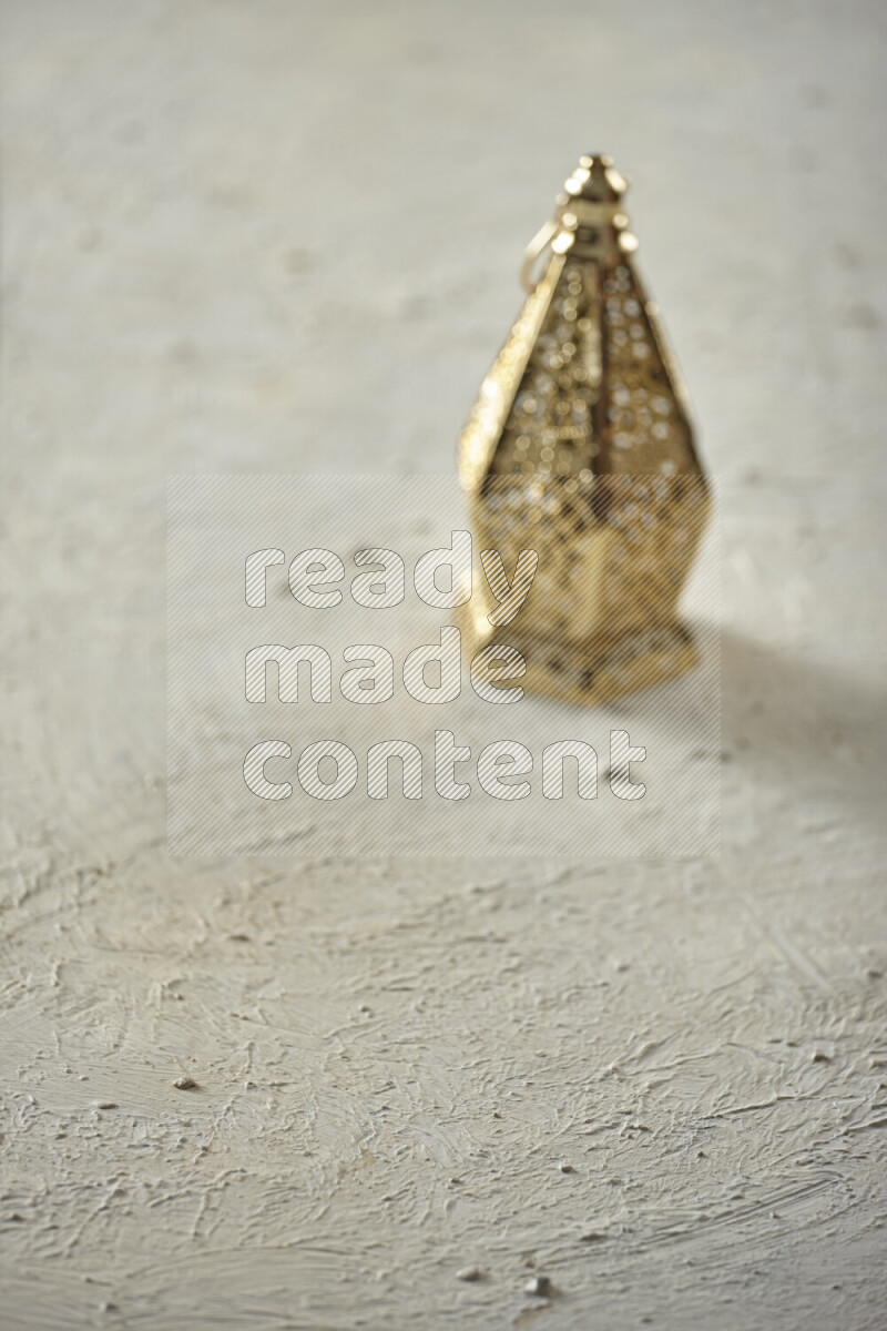 A lantern placed on a textured white background
