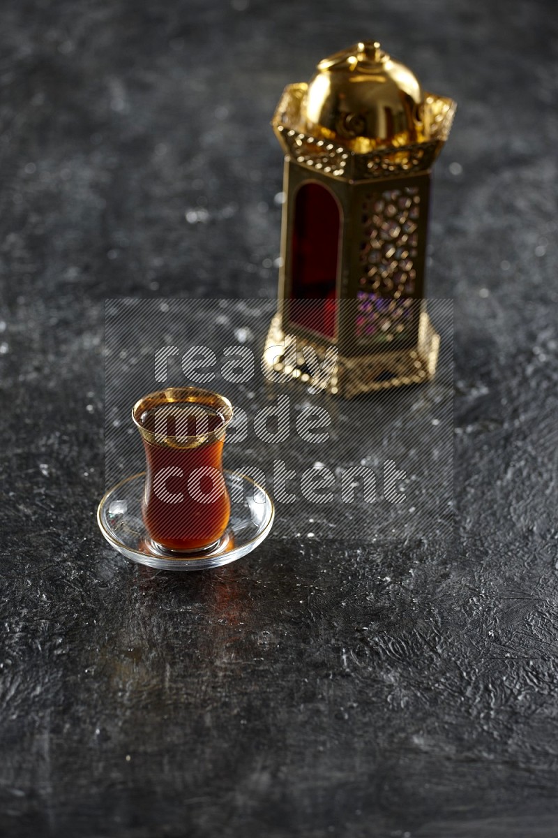 A golden lantern with different drinks, dates, nuts, prayer beads and quran on textured black background