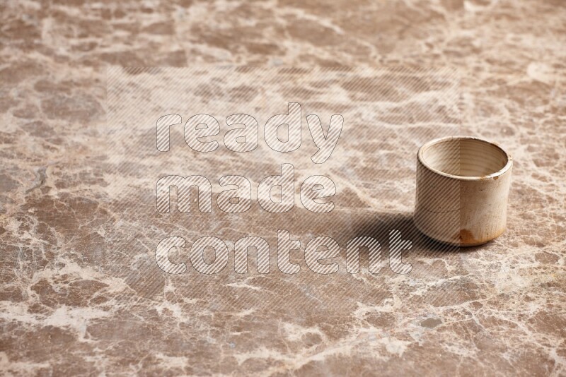 Pottery Cup on Beige Marble Flooring