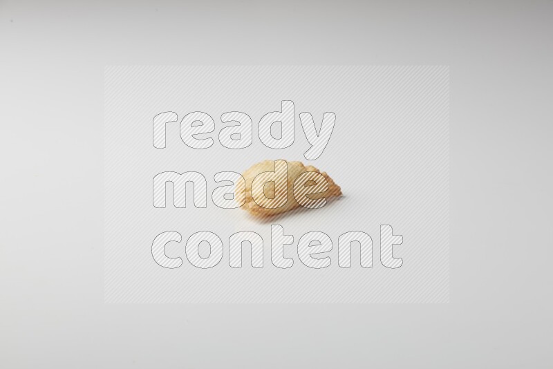 One fried sambosa on a white background
