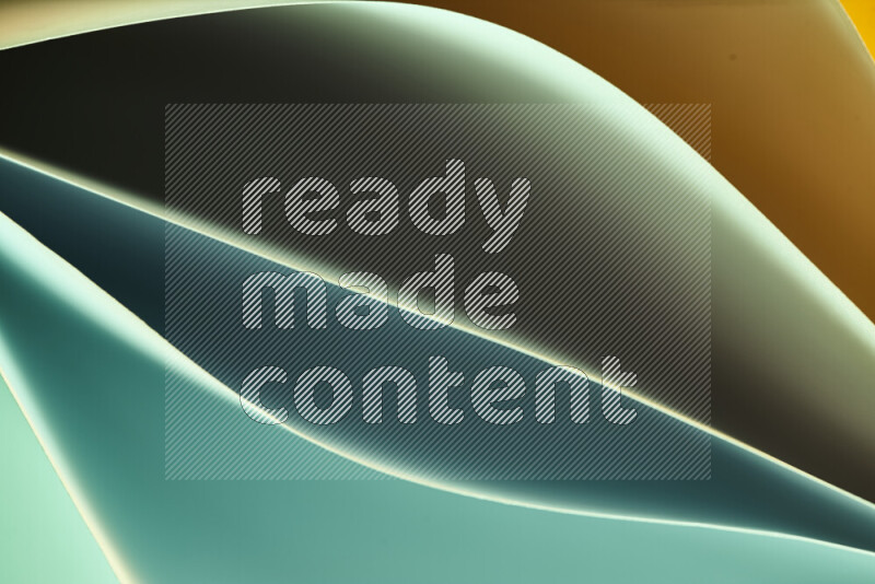 هذه الصورة تعرض تكوين فن الورق التجريدي مع منحنيات ورقية بتدرجات اللون الأخضر والبرتقالي المكونه بواسطة الضوء الملون