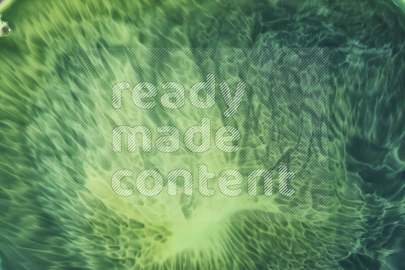 A close-up of abstract swirling patterns in green gradients