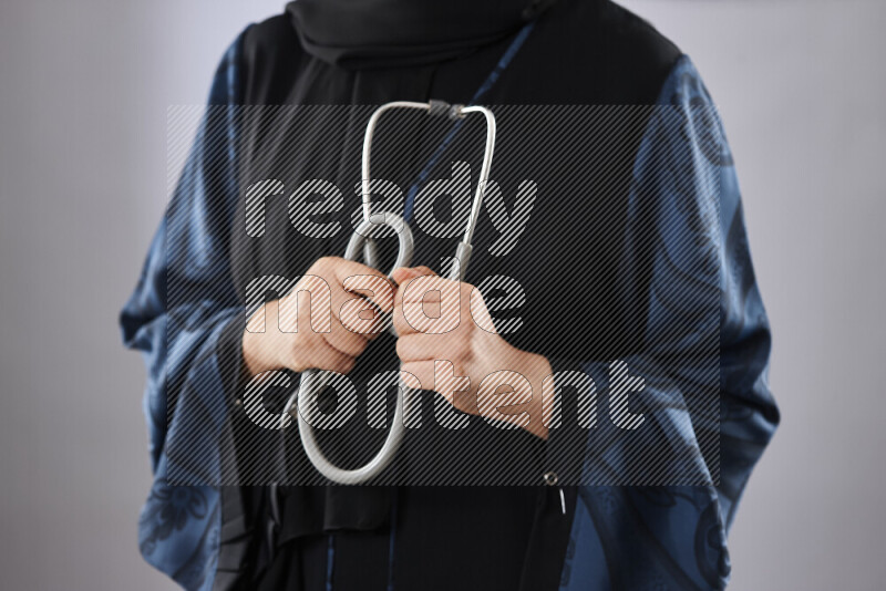 Female doctor wearing an abaya and medical attire in different positions