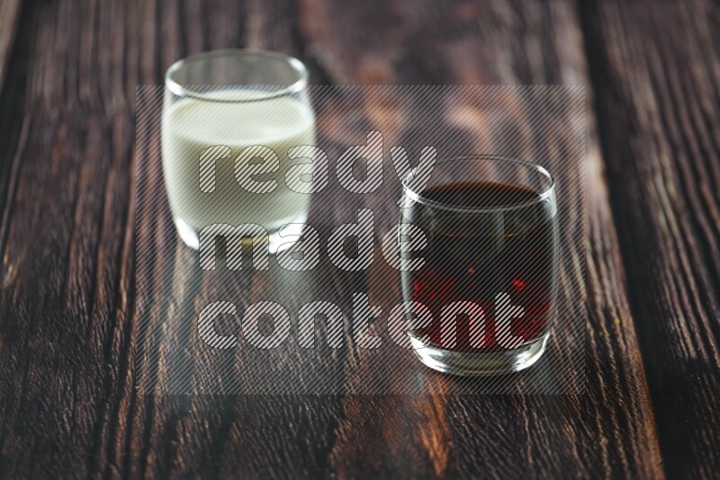 Cold drinks in a glass cup such as water, tamarind, qamar eldin, sobia, milk and hibiscus on wooden background